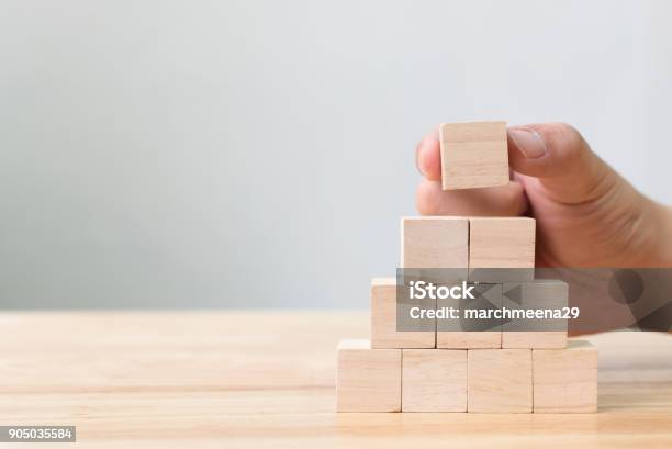 Hand Arranging Wood Block Stacking As Step Stair Business Concept For Growth Success Process Stock Photo - Download Image Now