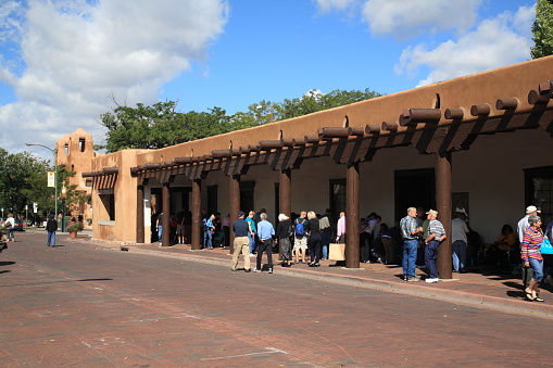 Santa Fe, New Mexico, USA - September 23, 2010: Shoppers & tourists at the Native American market in Santa Fe. The market is held at the Palace of the Governors, built in 1610.