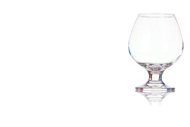 istock Empty glass of cognac on the leg. 905041534