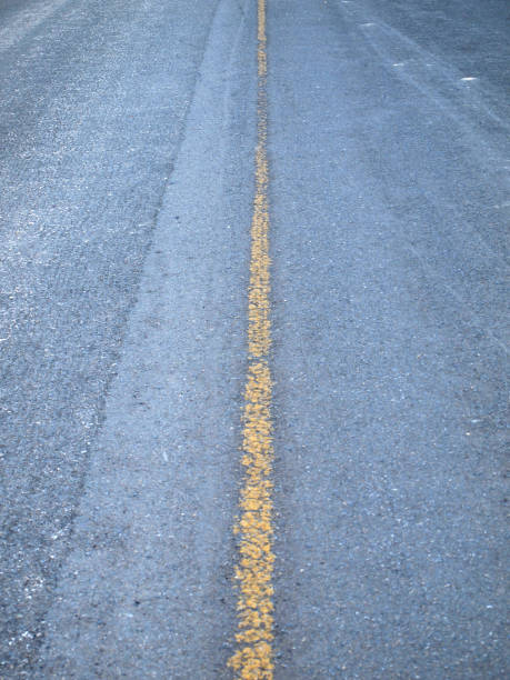istock Close up road divide yellow line 905061410