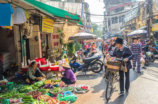Hanoi,Vietnam - October 31,2017 : Busy local daily life of the morning street market in Hanoi, Vietnam. A busy crowd of sellers and buyers in the market.