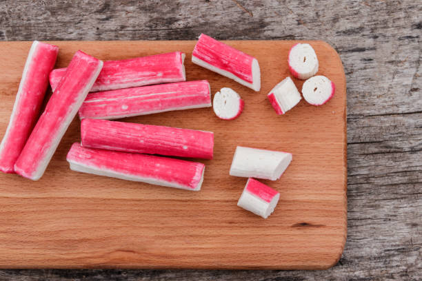 istock Crab sticks on cutting board on rustic wooden table 905075254