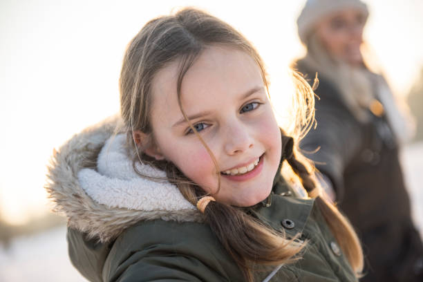 istock Mother and daughter smiling in the winter 905090838