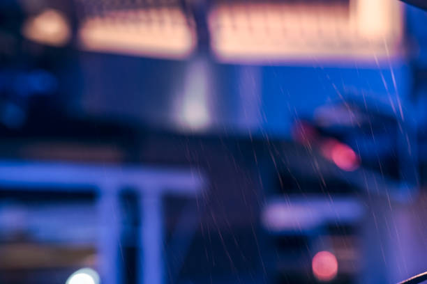 Blurred background light in the night traffic and raining drop