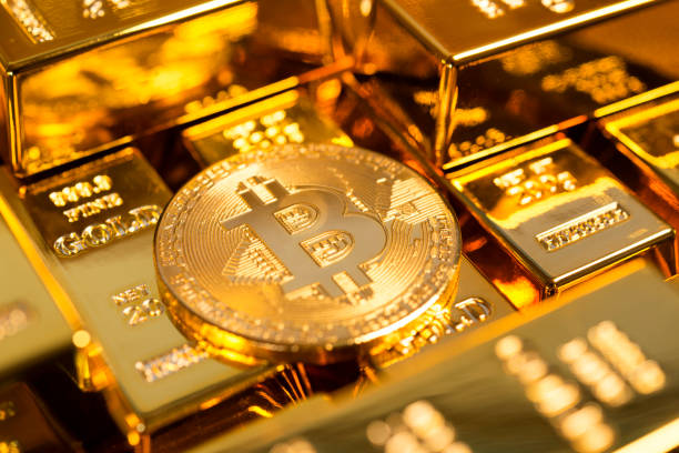 Bitcoin among gold bars Izmir, Turkey - January 14, 2018: Memorial bitcoin among gold bars. Bitcoin is a worldwide digital currency that isn't controlled by a central authority such as a government or bank. gold bitcoin stock pictures, royalty-free photos & images