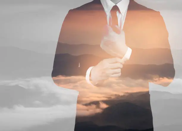 Double exposure of success business man mountain landscape background.time for business.concept freedom business.
