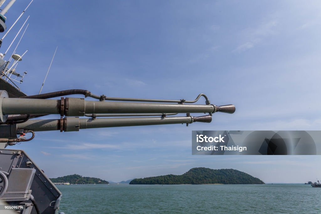 a shooting gun on the battleship The warships have various weapons like a shotgun gun shooting machine aircraft shooting and missiles inside warships have many control room for adjust the shooting Aiming Stock Photo