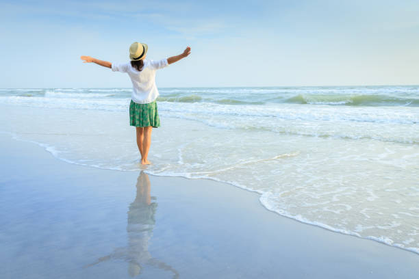 istock Happy woman on beach 905102220