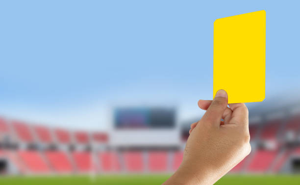istock Referee showing yellow card in the field 905105158