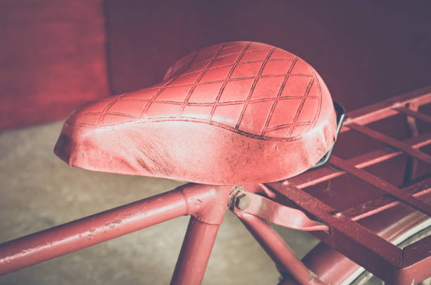 Red vintage bicycle seat / Close up and selective focus