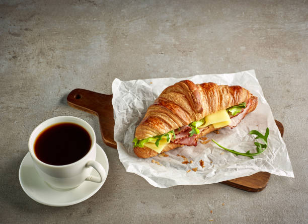 istock Croissant with ham and cheese on grey table 905105784