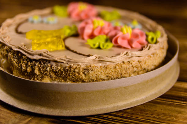 istock Kiev cake with cream on wooden table 905106156