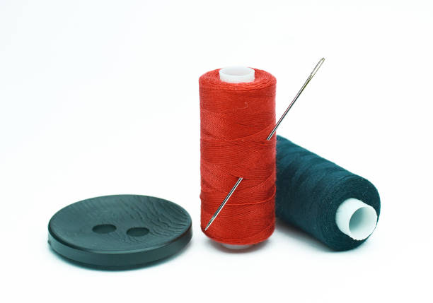 istock Sewing supplies and accessories for needlework. Fabric, spools of thread, scissors and thimbles on white background. 905112868