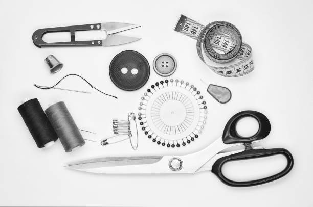 istock Sewing supplies and accessories for needlework. Fabric, spools of thread, scissors and thimbles on white background. 905112902