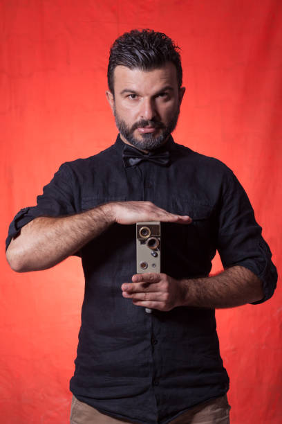 istock The photographer wit retro camera over colored background 905113062
