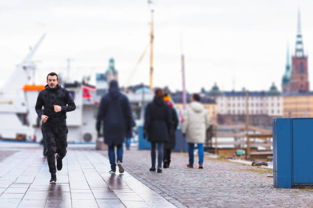 Handsome runner exercising by running and jogging in Stockholm
