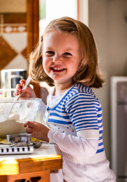 istock Little Girl Baking In Kitchen 905117654