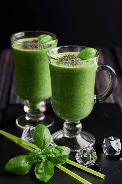 istock Blended green smoothie with ingredients on wooden table 905124992