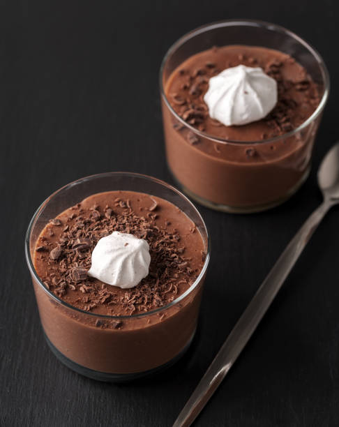 istock Chocolate mousse in a glasses on a black stone background. 905125258