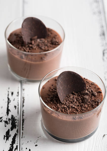 istock Chocolate mousse in a glasses on a white wood background. 905125296