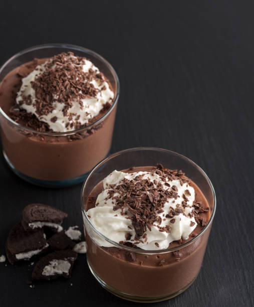 istock Chocolate mousse in a glasses on a black stone background. 905125370
