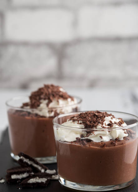 istock Chocolate mousse in a glasses on a black stone background. 905125398