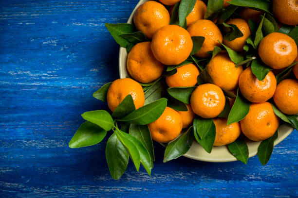 istock Fresh ripe mandarines on the rustic wooden background 905130802