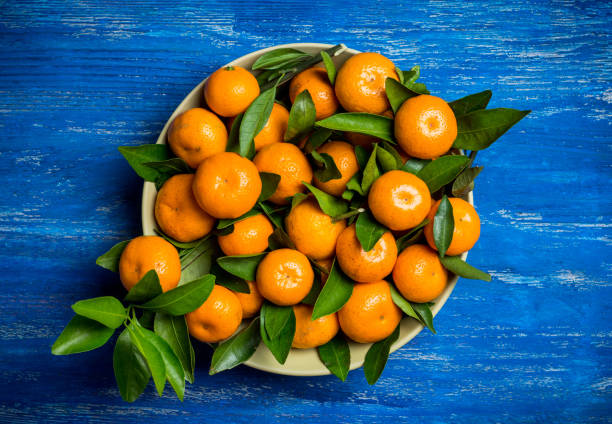 istock Fresh ripe mandarines on the rustic wooden background 905130804