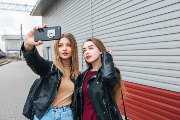 istock Two young girls taking selfie using smartphone 905130956