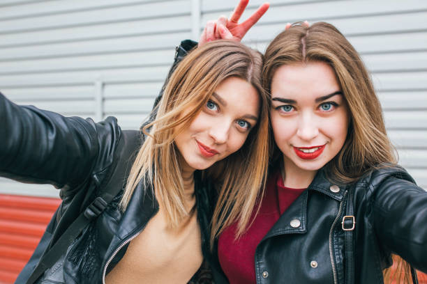 istock Two young girls taking selfie using smartphone 905131100