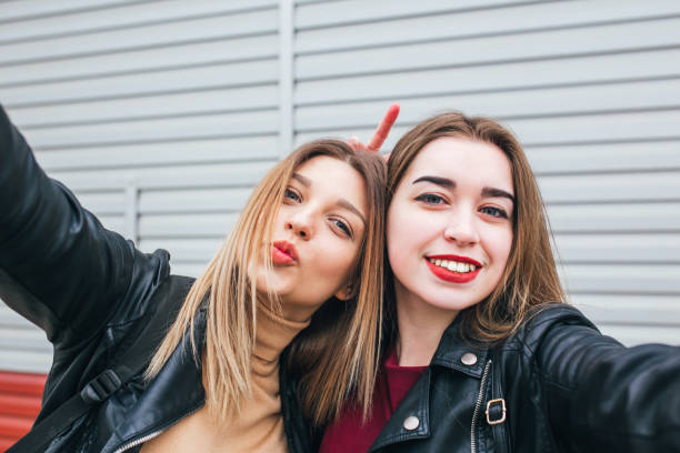istock Two young girls taking selfie using smartphone 905131302