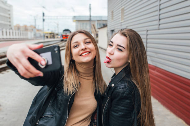 istock Two young girls taking selfie using smartphone 905131336
