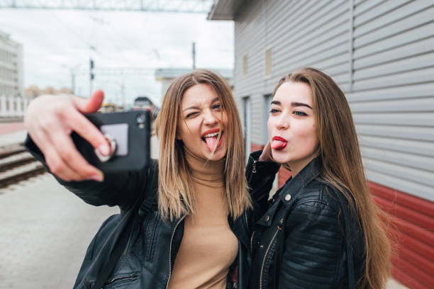 istock Two young girls taking selfie using smartphone 905131372