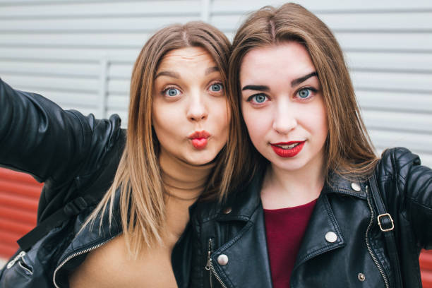istock Two young girls taking selfie using smartphone 905131458