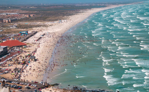istock Panoramic vista of overcrowded beach and beach goers 905131526