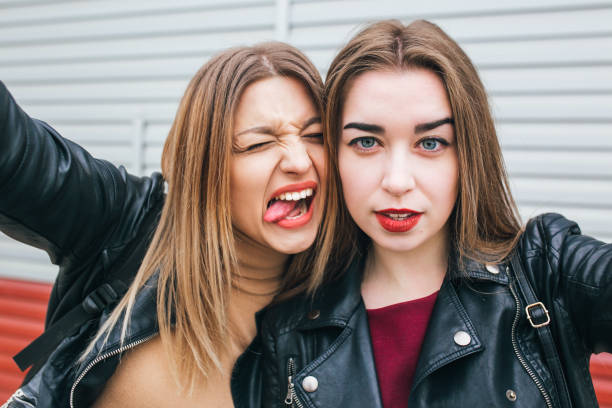 istock Two young girls taking selfie using smartphone 905131562