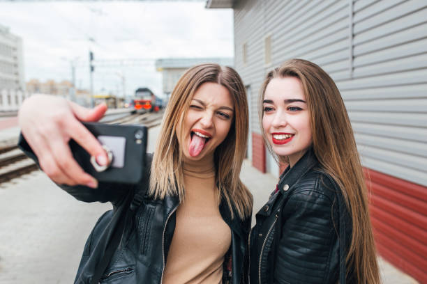istock Two young girls taking selfie using smartphone 905131596