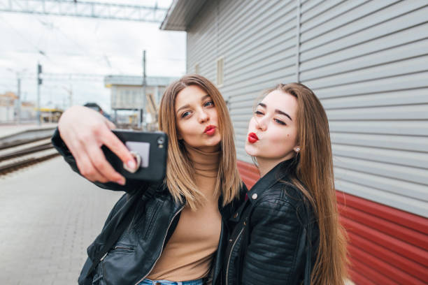 istock Two young girls taking selfie using smartphone 905131622