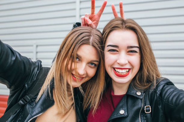 istock Two young girls taking selfie using smartphone 905131650
