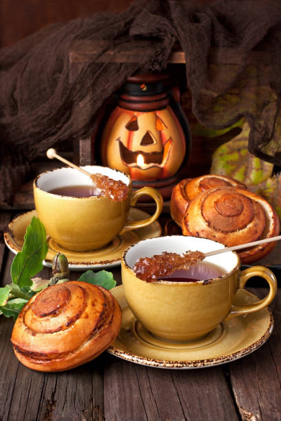 istock Baked sweet buns with cinnamon and tea cup on wooden table 905134340