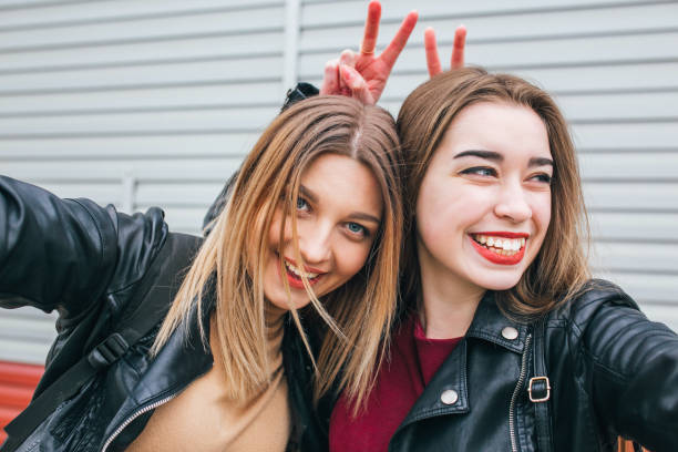 istock Two young girls taking selfie using smartphone 905134532