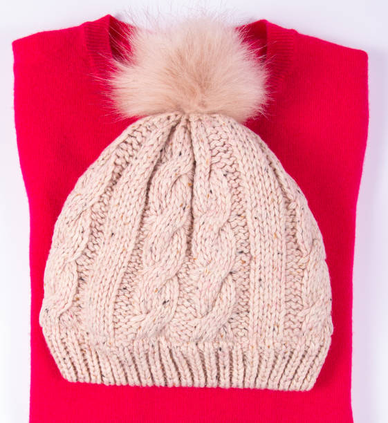 istock Wool hat and sweater for winter weather on a white background. 905142942
