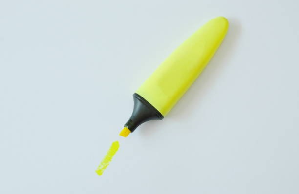 istock yellow highlight pen on white paper 905143658