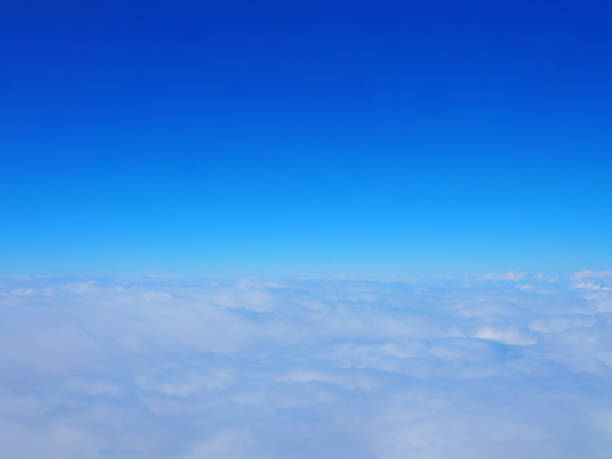 istock Early morning dark grey cloud field with clear gradient blue sky glowing horizon above 905146862