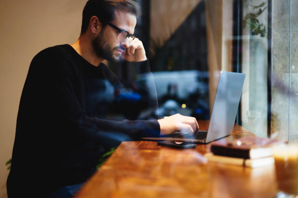 istock Intelligent copywriter thinking about writing new ideas for business project using modern laptop while searching information on website sources. Freelancer using high speed internet connection 905148446