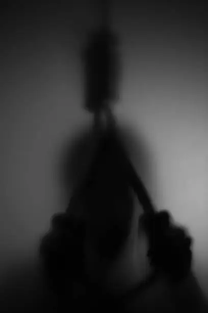 Shadow blur of man who want to commit suicide by hanging rope noose, fine image of dark and light
