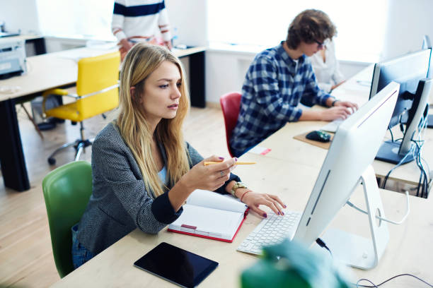 istock Young female student journalist searching information on web page for writing training press release and getting good mark using computer and touchpad with mock up screen connected to internet 905155218