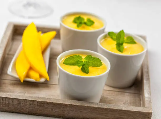 Photo of Three bowls of mango mousse
