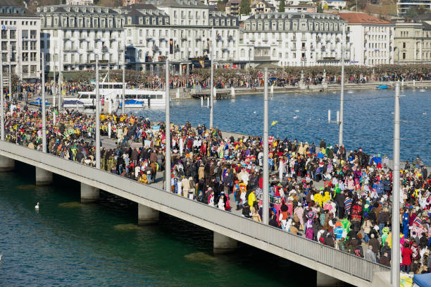 View to the crowd of people at the bridge watching the parade during carnival in Lucerne, Switzerland. Lucerne, Switzerland - February 20, 2012: View to the crowd of people at the bridge watching the parade during carnival in Lucerne, Switzerland. lucerne switzerland stock pictures, royalty-free photos & images