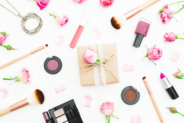 istock Woman workspace with gift box, pink roses, cosmetics, diary on white background. Top view. Flat lay. Woman day. 905159702
